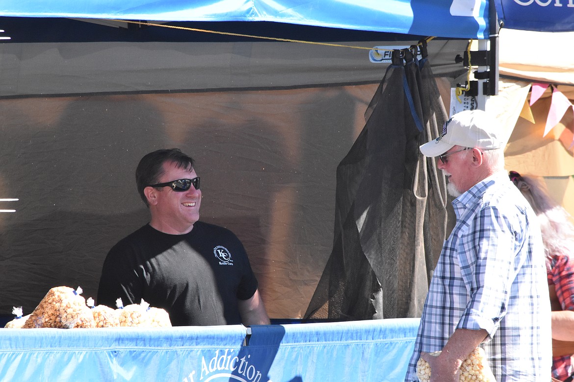 A vendor smiles as he chats with an attendee of the festival.