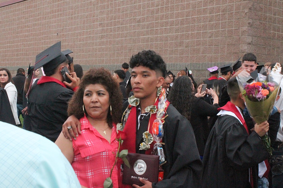 Wahluke High School graduate Fernando Adame poses for photos with his mom, Irma Naranjo, after the graduation ceremony Friday.