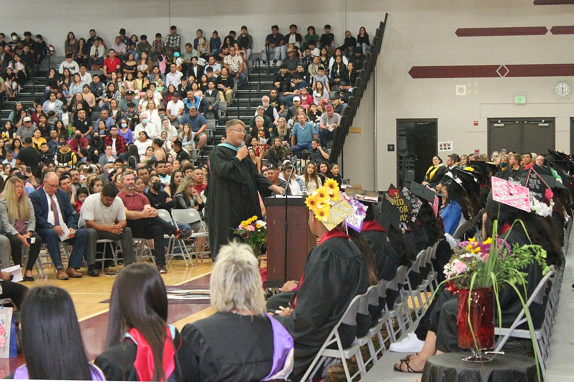 Senior Class Advisor Joel Dugan addresses seniors and their families Friday at the Wahluke High School graduation.