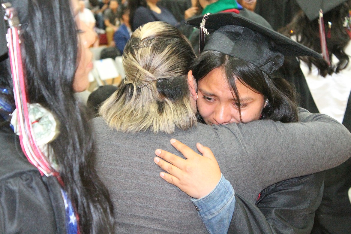 A Wahluke senior shares a hug with family during the parent tribute at the high school’s graduation Friday.