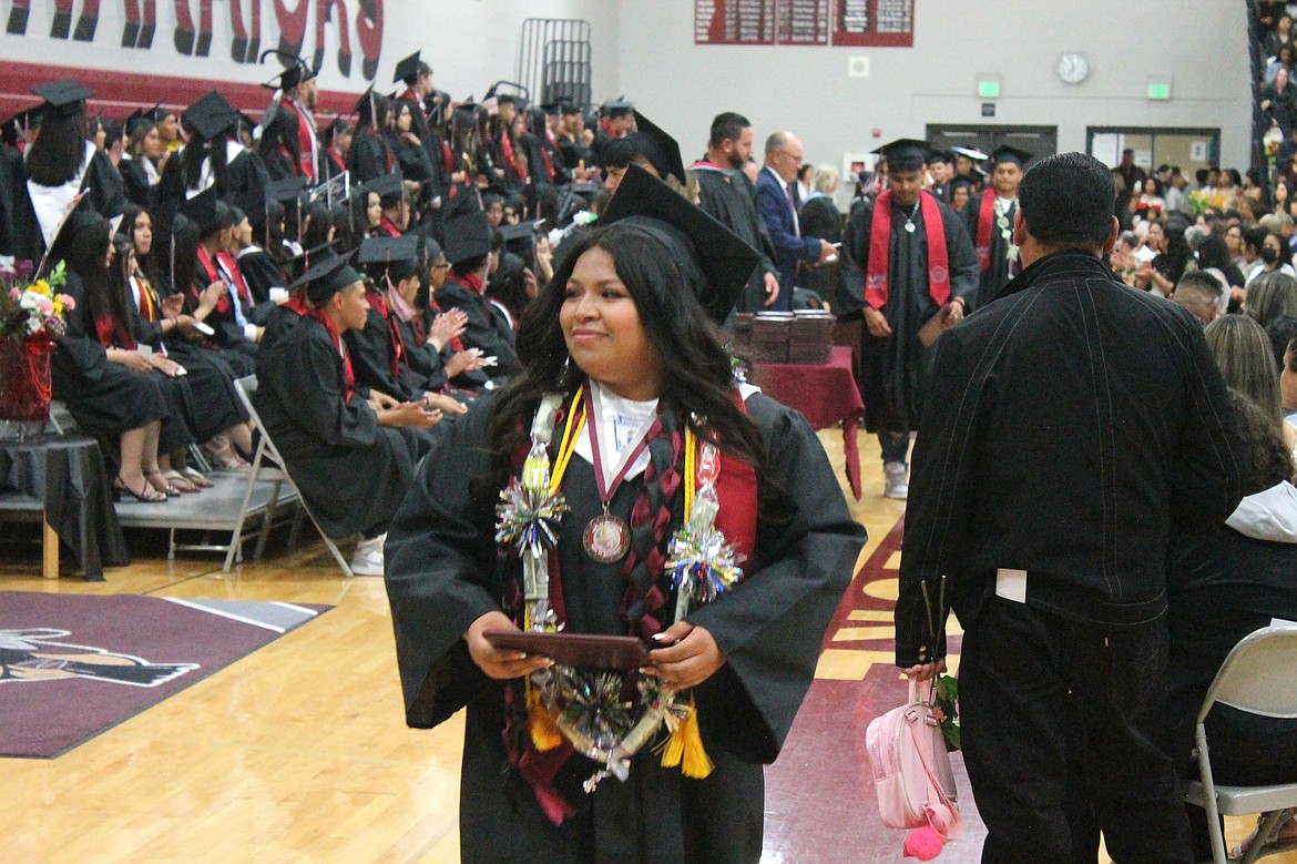 A Wahluke High School senior holds her hard-earned diploma at graduation Friday night. This year’s class had a whirlwind final three years of high school trying to keep up with homework and extracurriculars in the midst of a pandemic - and succeeded in reaching their goals.