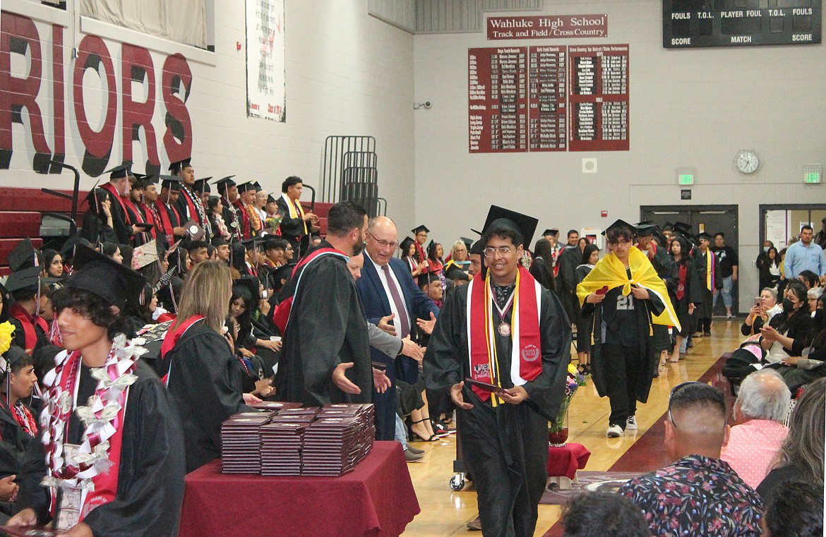 Wahluke High School seniors receive their diplomas at their graduation Friday.