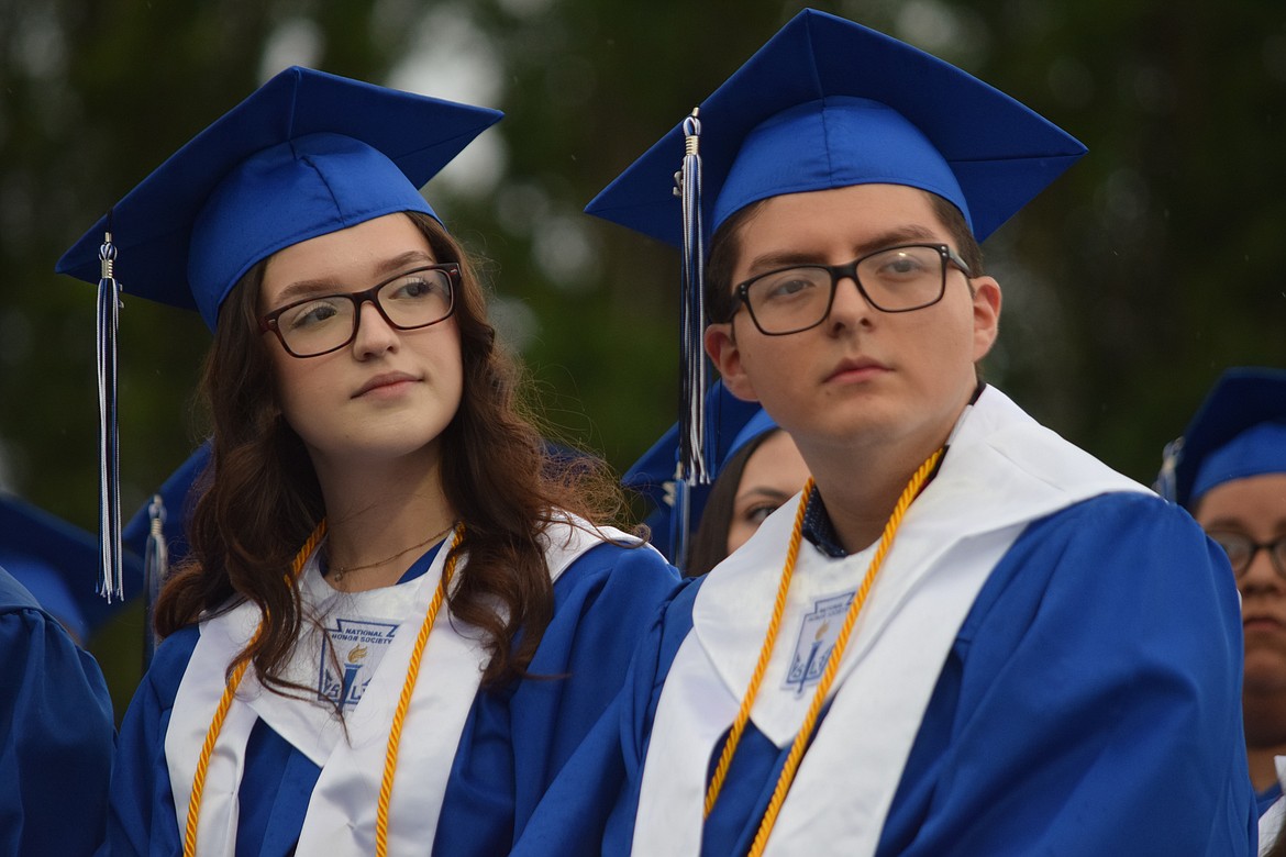 Warden High School salutatorian Alyssa Valdez (left) and valedictorian Axel Ramirez (right) listen during the Warden High School 2022 graduation ceremony on Friday.