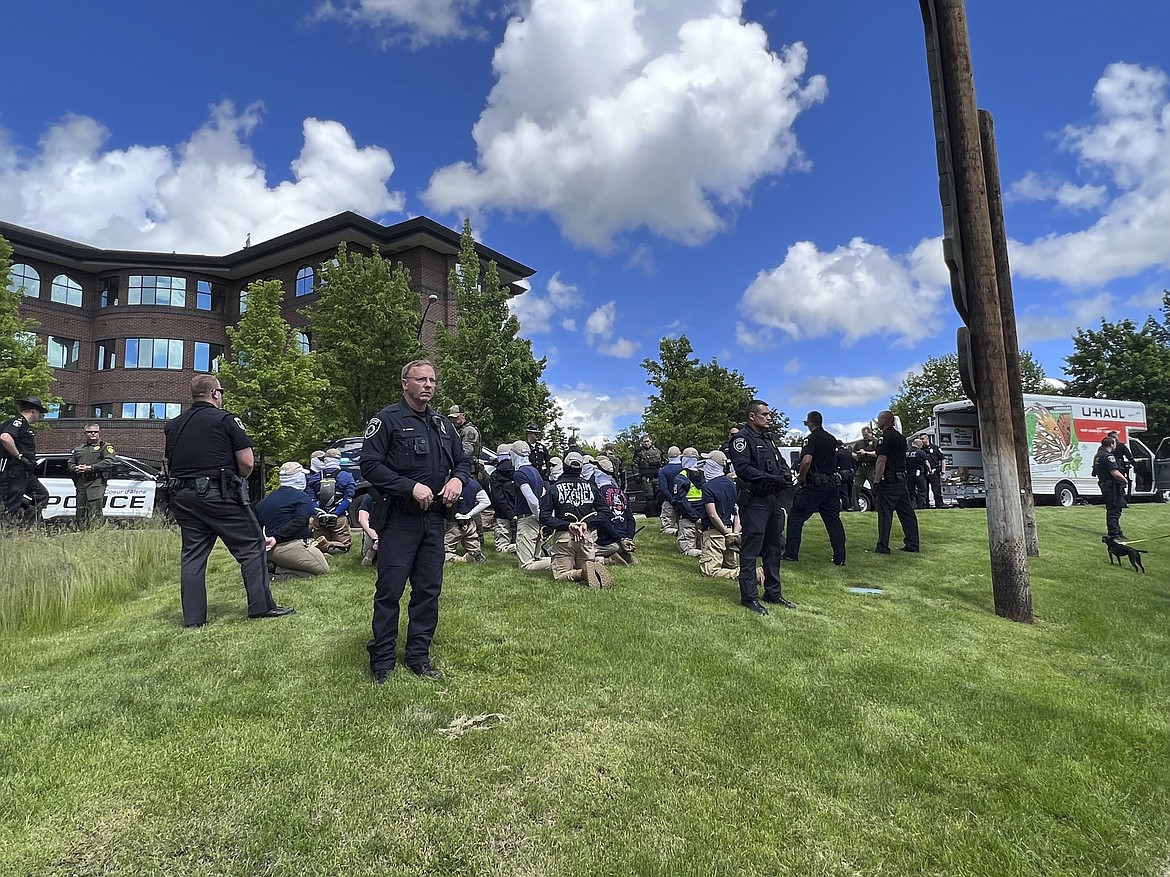 Authorities arrest members of the white supremacist group Patriot Front near an Idaho pride event Saturday, June 11, 2022, after they were found packed into the back of a U-Haul truck with riot gear. (Georji Brown via AP)