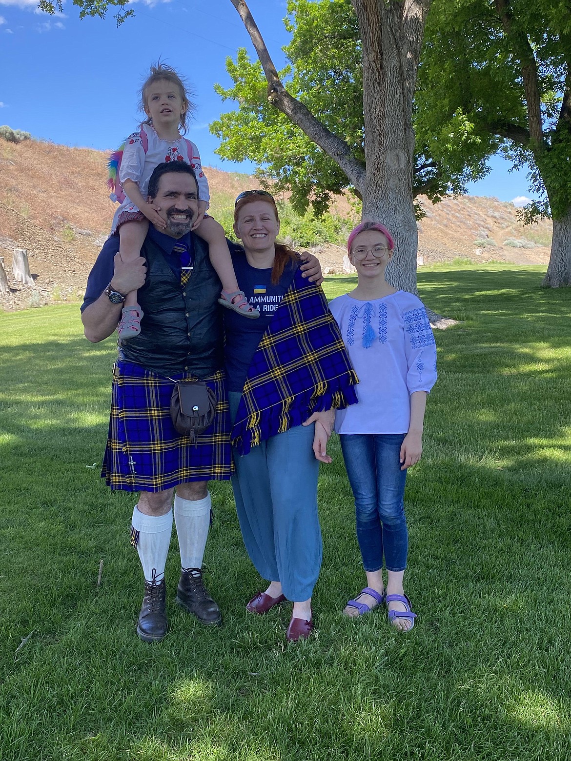 Kelly and Lidiya Clear, of Ephrata, pose with two of their children sporting different articles made from the tartan they designed. Proceeds from sales of items made from the tartan go to support a Ukrainian charity.