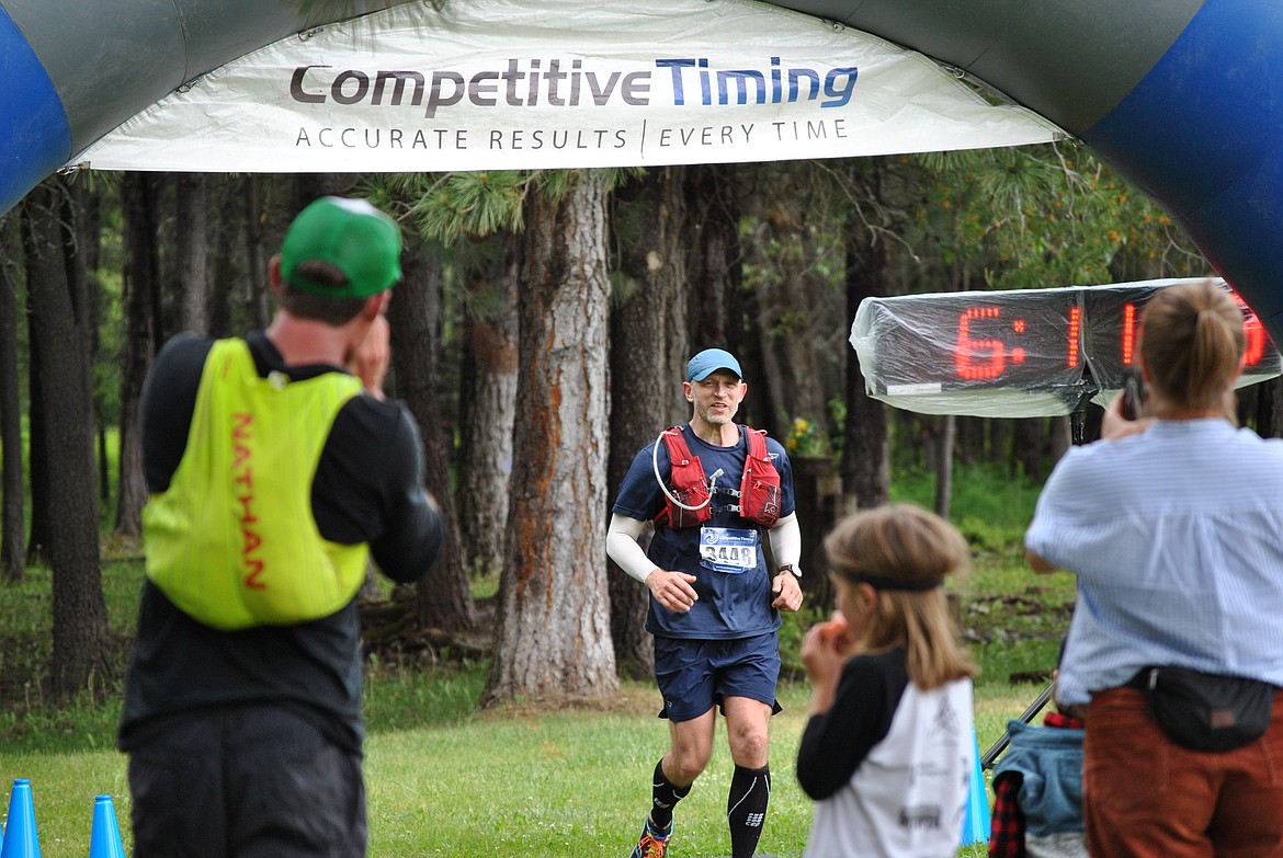 Missoula runner, Matthew Jacupcak crosses the finish line at the St. Regis Community Park completing his 50K as his family and friends cheer him on Saturday afternoon. (Mineral Independent/Amy Quinlivan)