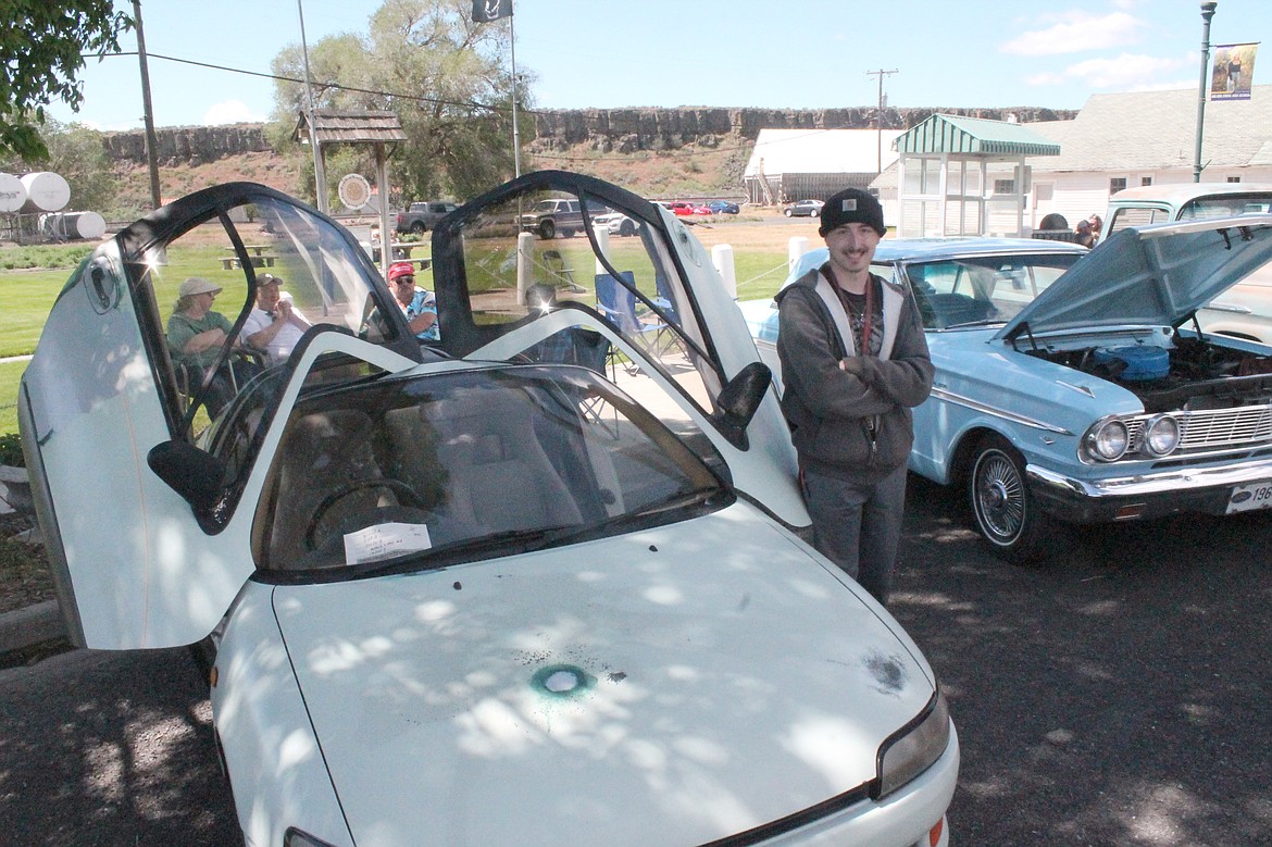 Jesse Hasch of Moses Lake stands beside his 1991 Toyota Sera. The butterfly doors are designed to allow the car to park in very tight spaces, he said.