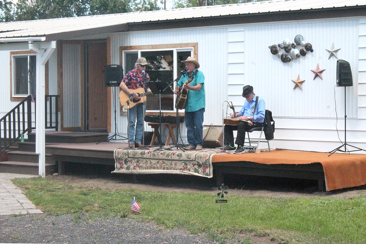 An impromptu trio plays bluegrass music on the front porch of a house on Railroad Street in Wilson Creek Saturday. The music accentuated the town’s Little Big Show.