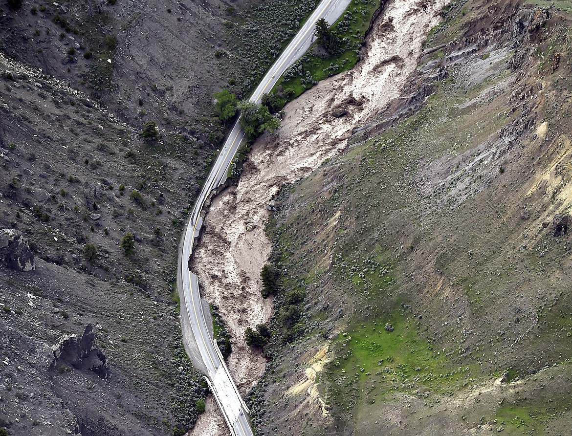 The highway between Gardiner and Mammoth in Montana is washed out trapping tourists in Gardiner, as historic flooding damages roads and bridges and floods homes along area rivers on Monday, June 13, 2022. (Larry Mayer/The Billings Gazette via AP)