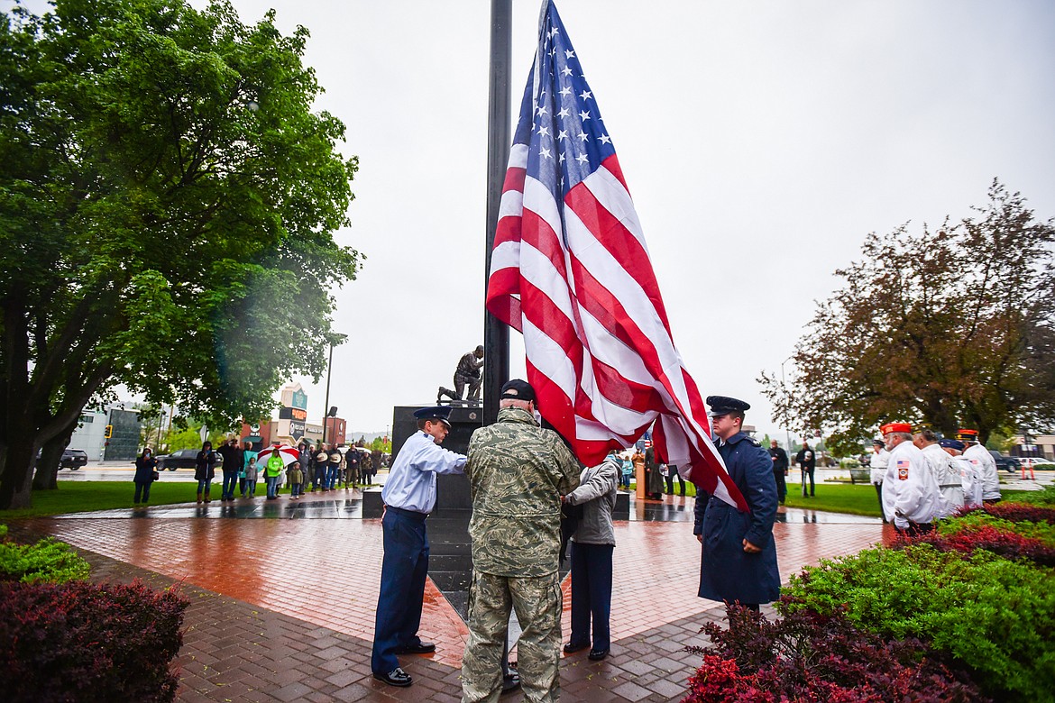 Members of the Flathead Composite Squadron of the Civil Air Patrol raise a new American flag after retiring the previous one during a Flag Day ceremony at Depot Park in Kalispell on Tuesday, June 14. (Casey Kreider/Daily Inter Lake)