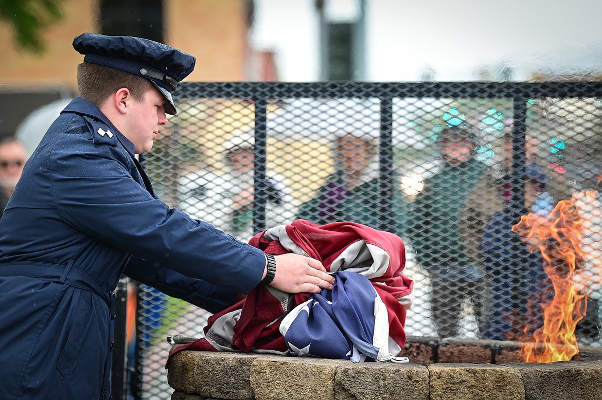 Cadet Lt. Col. Gary Petro of the Flathead Composite Squadron of the Civil Air Patrol retires the previous American flag that flew over Depot Park during a Flag Day ceremony on Tuesday, June 14. (Casey Kreider/Daily Inter Lake)