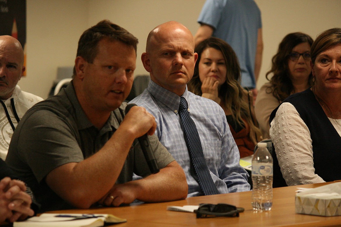 Gregg Fultz (left), Othello School District risk manager, talks about some of the measures taken by the district to increase security during the Othello School Board meeting Monday. Director of teaching and learning John Wiseman is at right.