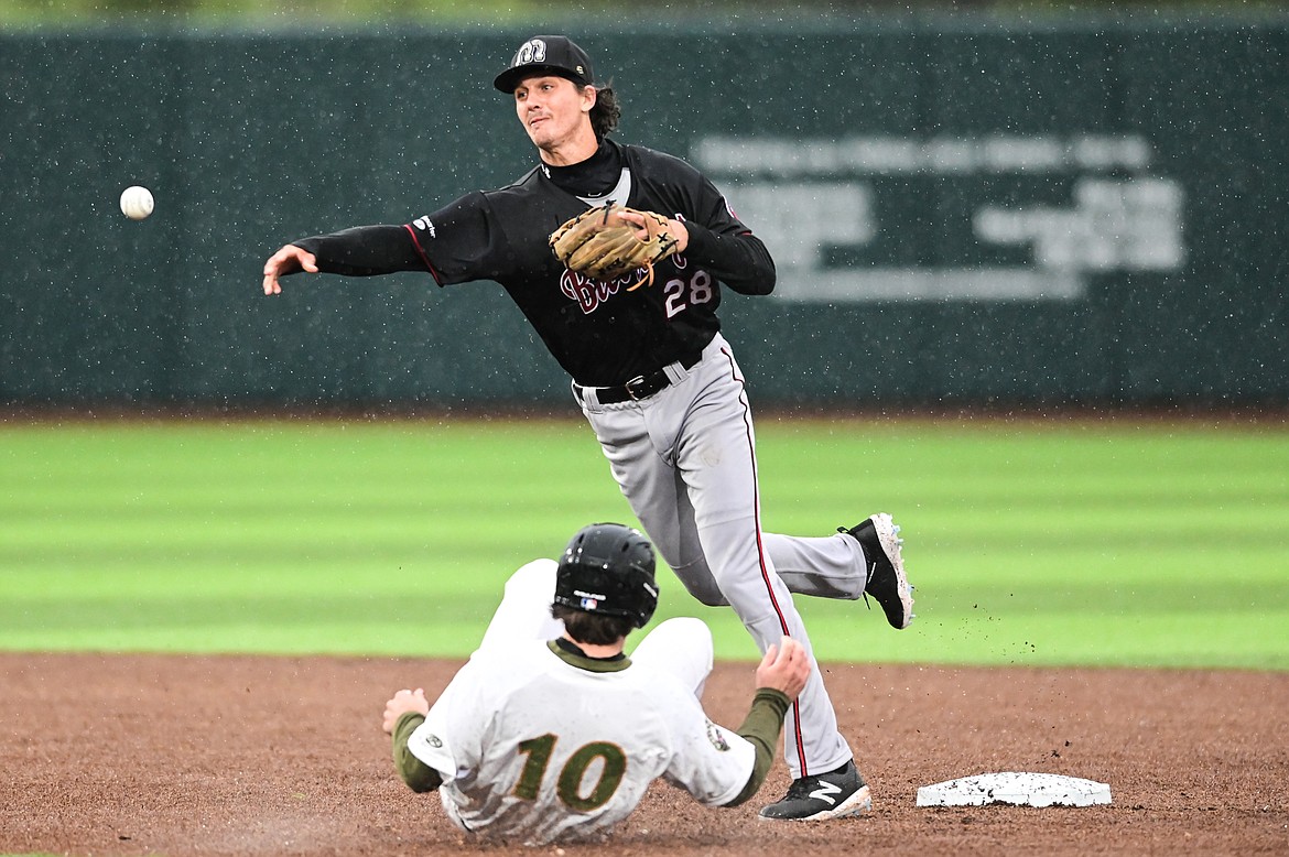 Billings Mustangs shortstop Mason Dinesen (28) throws to first for a double play against the Glacier Range Riders at Flathead Field on Tuesday, June 14. (Casey Kreider/Daily Inter Lake)