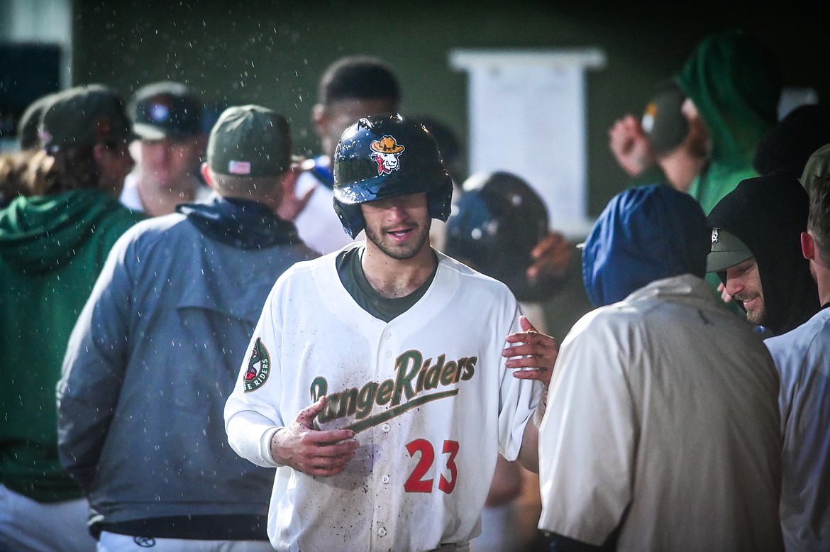 Glacier Range Riders' Sam Linscott (23) is congratulated by teammates after scoring a run in the bottom of the sixth inning against the Billings Mustangs at Flathead Field on Tuesday, June 14. (Casey Kreider/Daily Inter Lake)