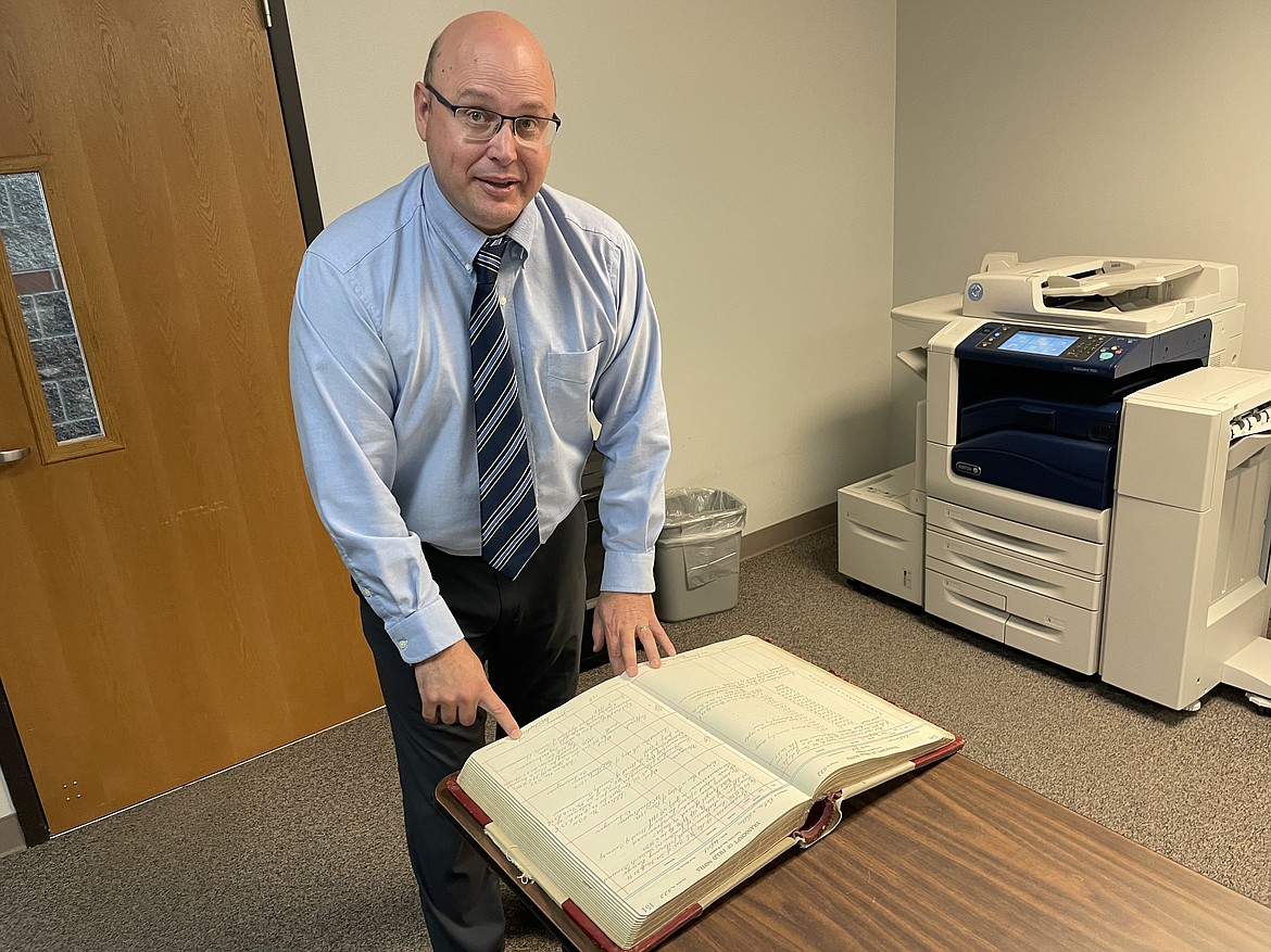 Grant County Engineer David Bren with a county surveyor’s notes from 1911. Bren has been the county engineer for about a month and said he has always had a passion for construction.