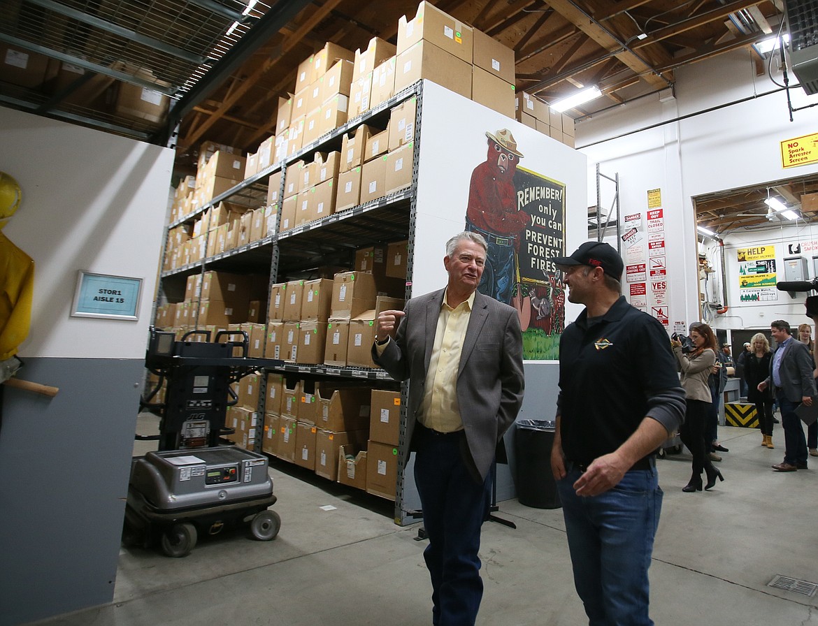 Gov. Brad Little speaks with Idaho Department of Lands director Dustin Miller during a Tuesday morning tour of the Coeur d’Alene Interagency Fire Cache.