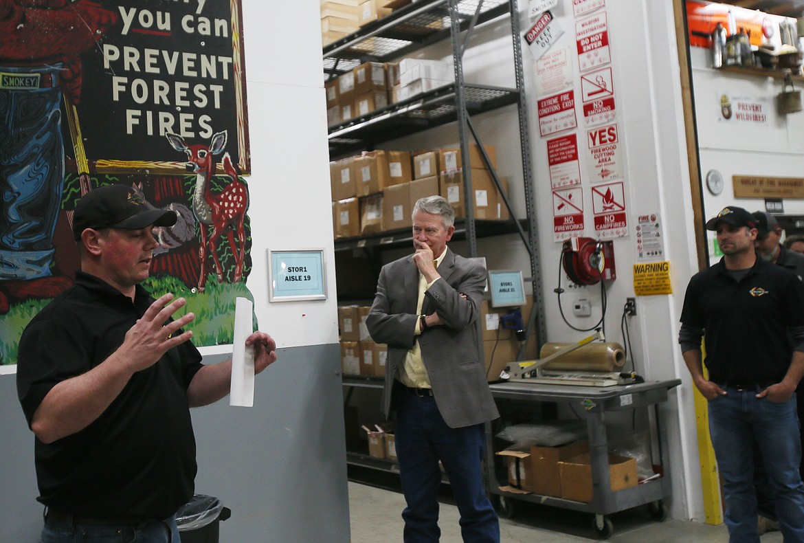 Gov. Brad Little, center, listens as Idaho Department of Lands Fire Cache manager Bjorn Jordan discusses inventory and interagency collaboration during a tour of the facility Tuesday.