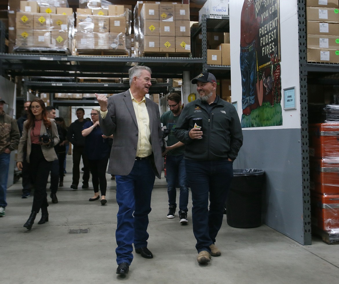 Gov. Brad Little, left, and Idaho Department of Lands fire management chief Josh Harvey on Tuesday walk through the Coeur d'Alene Interagency Fire Cache.