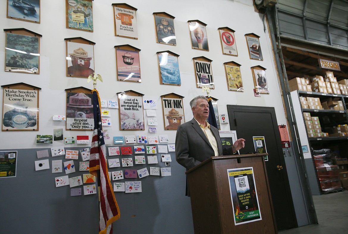 Surrounded by Smokey the Bear posters, Gov. Brad Little discusses wildfire preparedness during a visit to the Idaho Department of Lands' Coeur d'Alene Interagency Fire Cache.