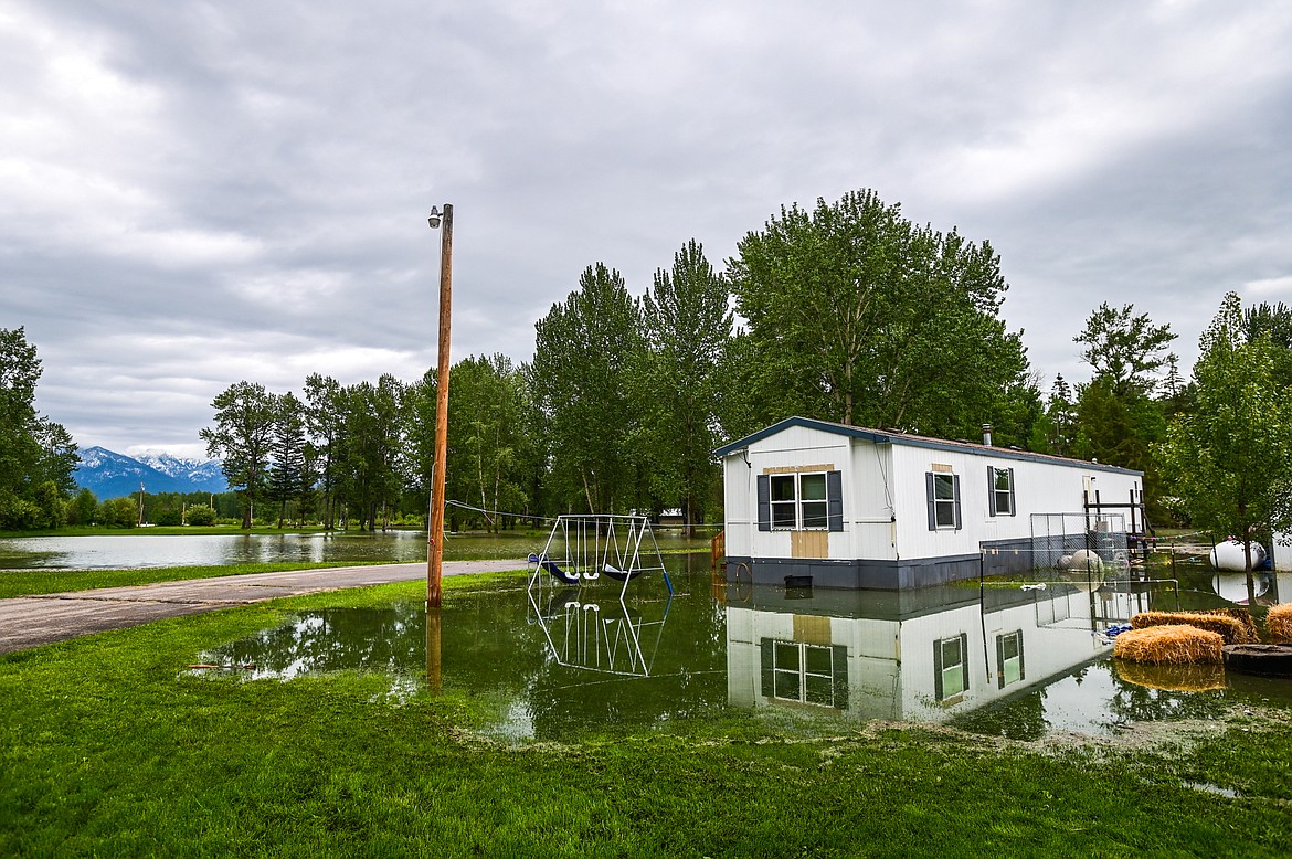 Rising flood waters from the Flathead River surround a home at Spruce Park On the River RV Park & Campground in Evergreen on Wednesday, June 15. (Casey Kreider/Daily Inter Lake)