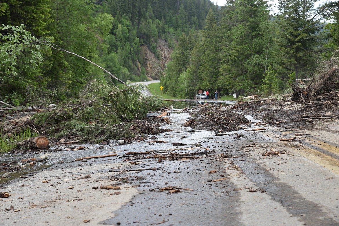 Water spills onto Yaak River Road in Lincoln County on Wednesday, June 15. (Scott Shindledecker/The Western News)