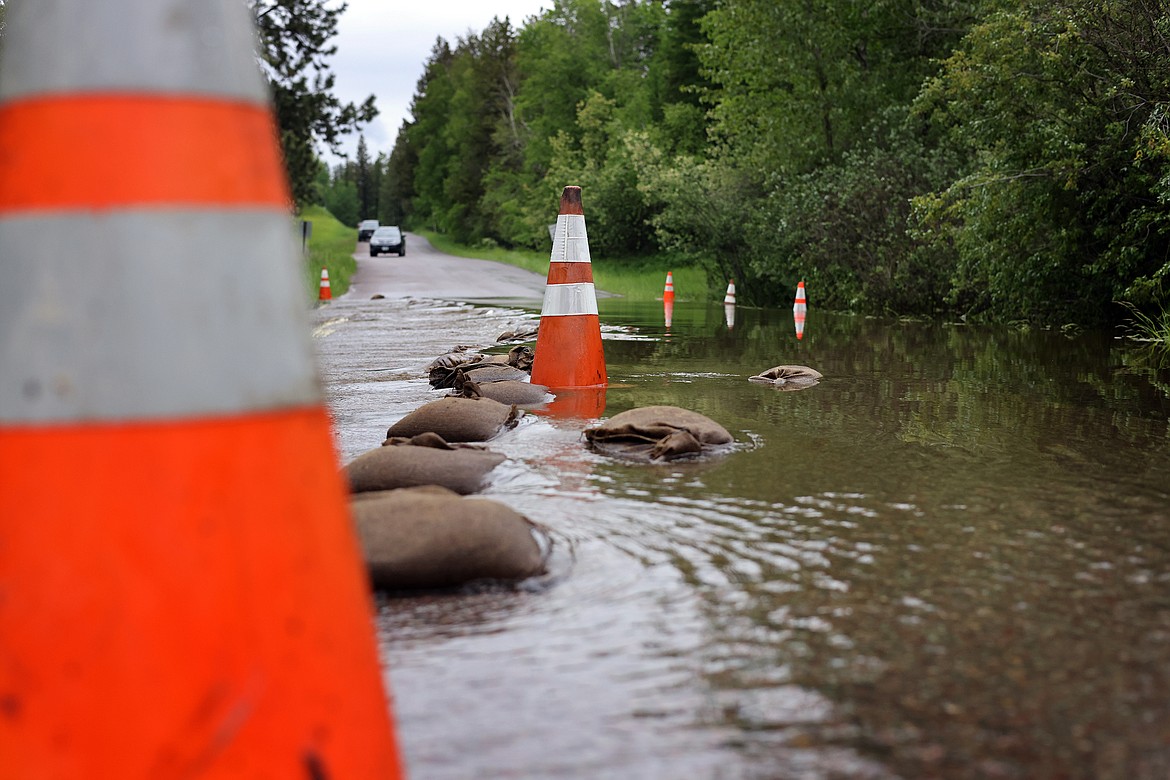 Garnier Creek flows over North Hilltop Road in Columbia Falls Wednesday, June 15. (Jeremy Weber/Daily Inter Lake)