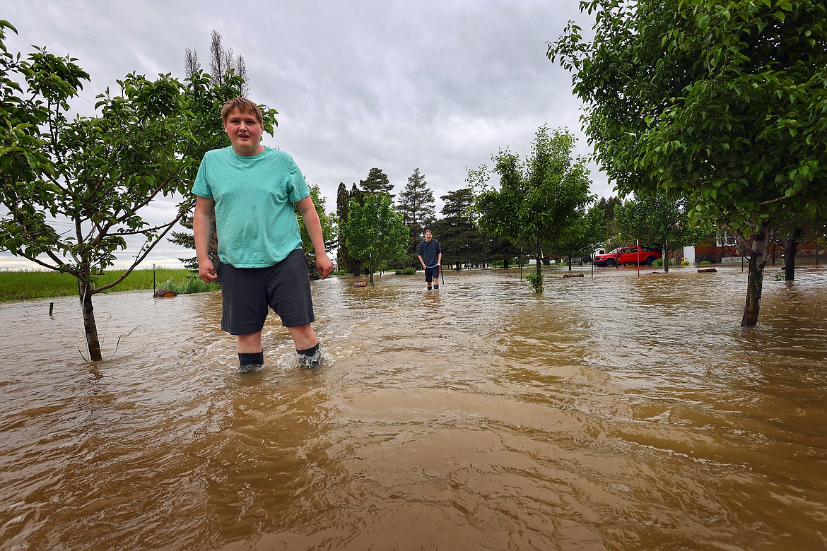 Residents wade through flood waters along US 2 in Columbia Falls Wednesday, June 15. (Jeremy Weber/Daily Inter Lake)