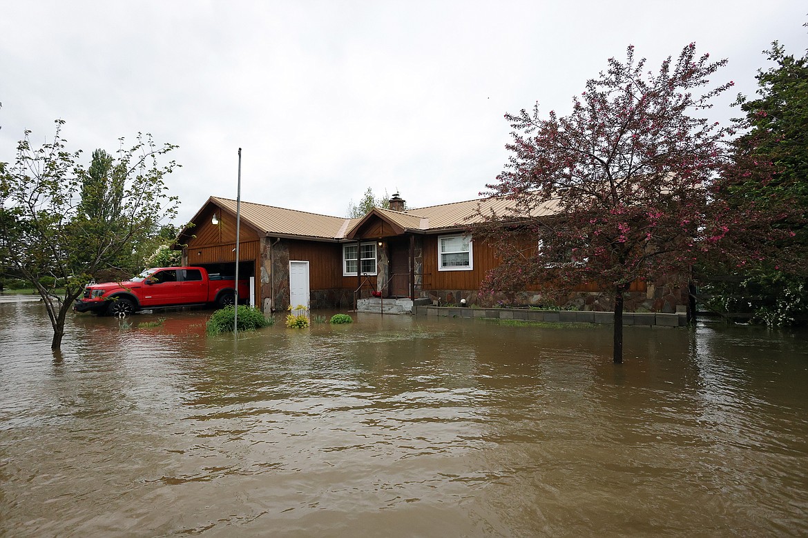 Flood waters surround a home on U.S. Hwy 2 in Columbia Falls Wednesday, June 15. (Jeremy Weber/Daily Inter Lake)