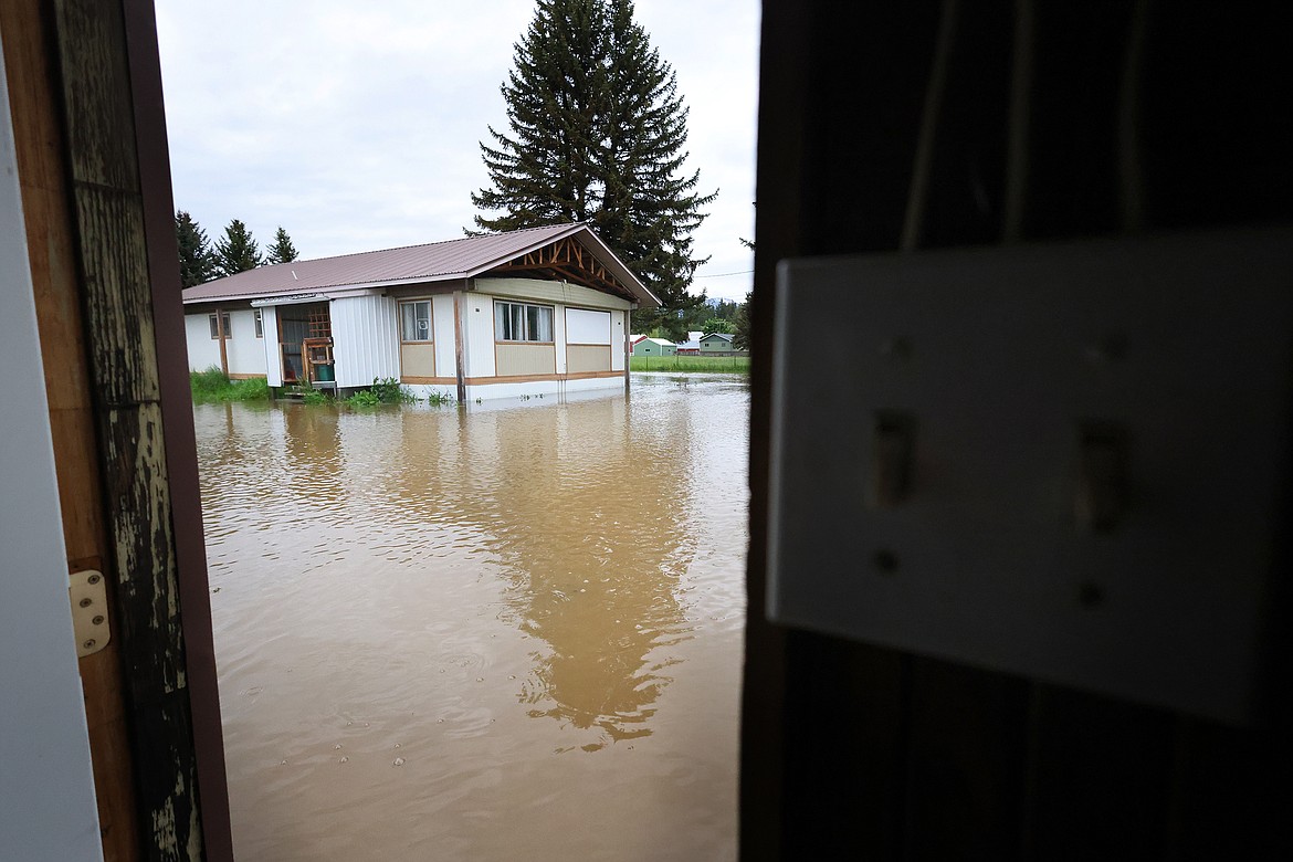 Flood waters surround a home on U.S. Hwy 2 in Columbia Falls Wednesday, June 15. (Jeremy Weber/Daily Inter Lake)