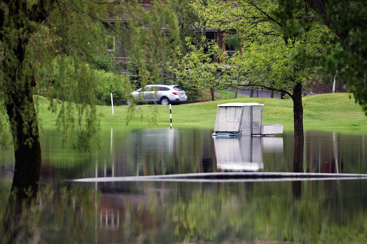 A golf cart sits beneath flood water at Meadow Lake Golf Course in Columbia Falls Wednesday, June 15. (Jeremy Weber/Daily Inter Lake)