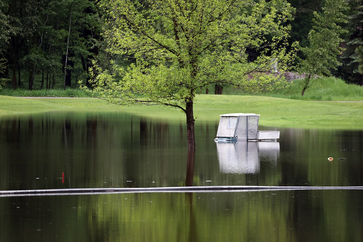 A golf cart sits beneath flood water at Meadow Lake Golf Course in Columbia Falls Wednesday, June 15. (Jeremy Weber/Daily Inter Lake)