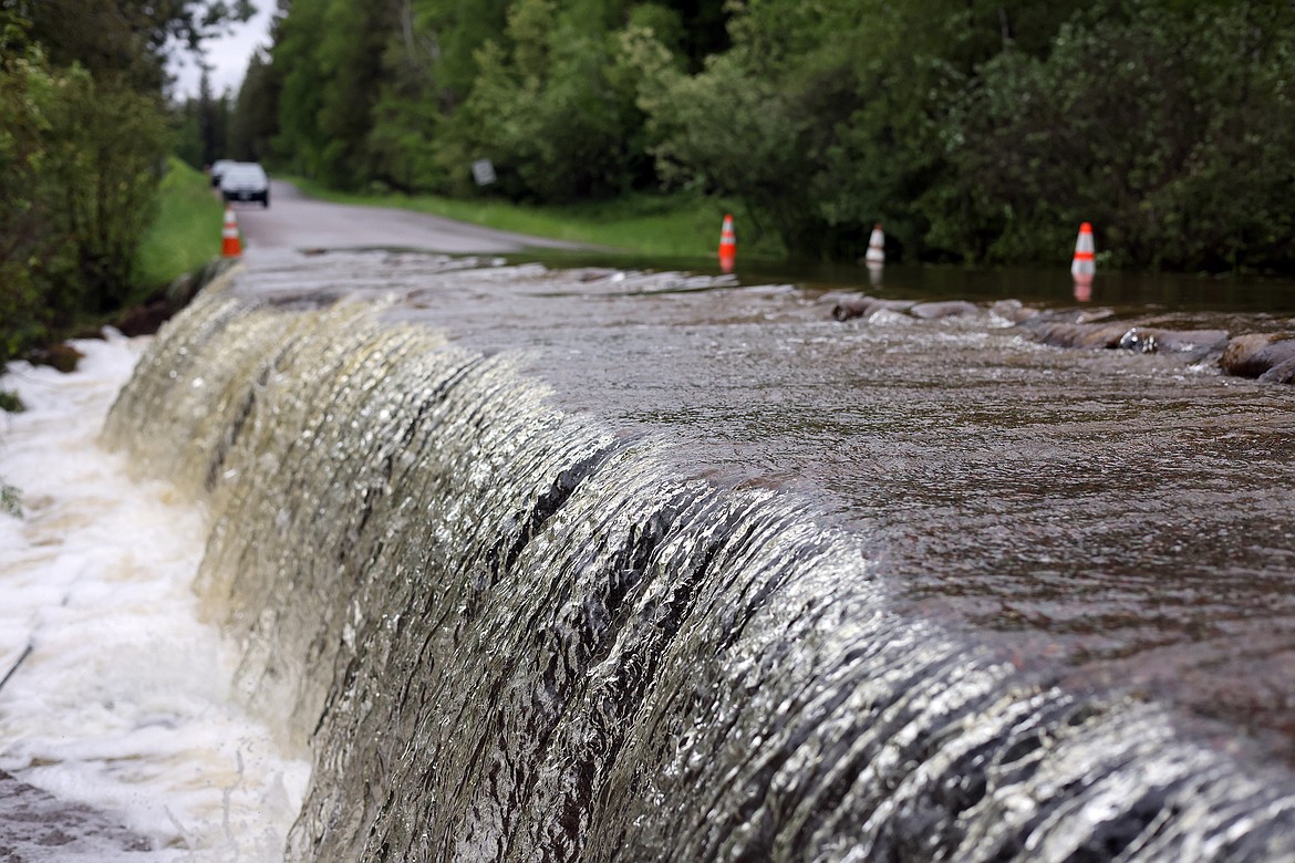 Garnier Creek flows over North Hilltop Road in Columbia Falls Wednesday, June 15. (Jeremy Weber/Daily Inter Lake)