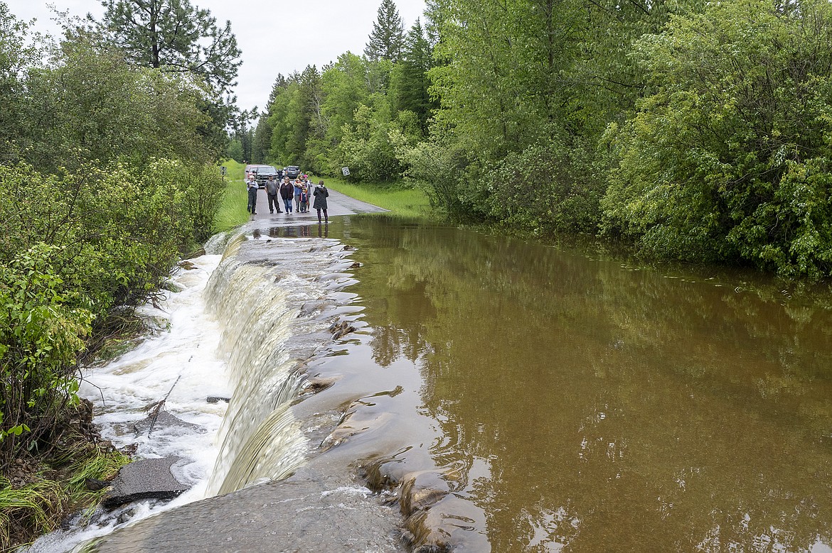 Flood water spill across North Hilltop Road in Columbia Falls on Wednesday, June 15. There was concern the culvert could fail entirely, sending a wall of water downstream. (Chris Peterson/Hungry Horse News)