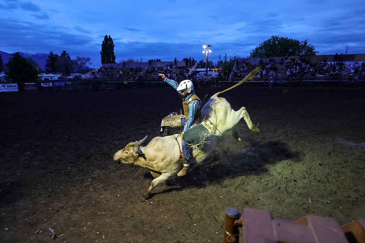 A bull rider has one last ride for the night the Blue Moon Rodeo last Thursday. (JP Edge photo)