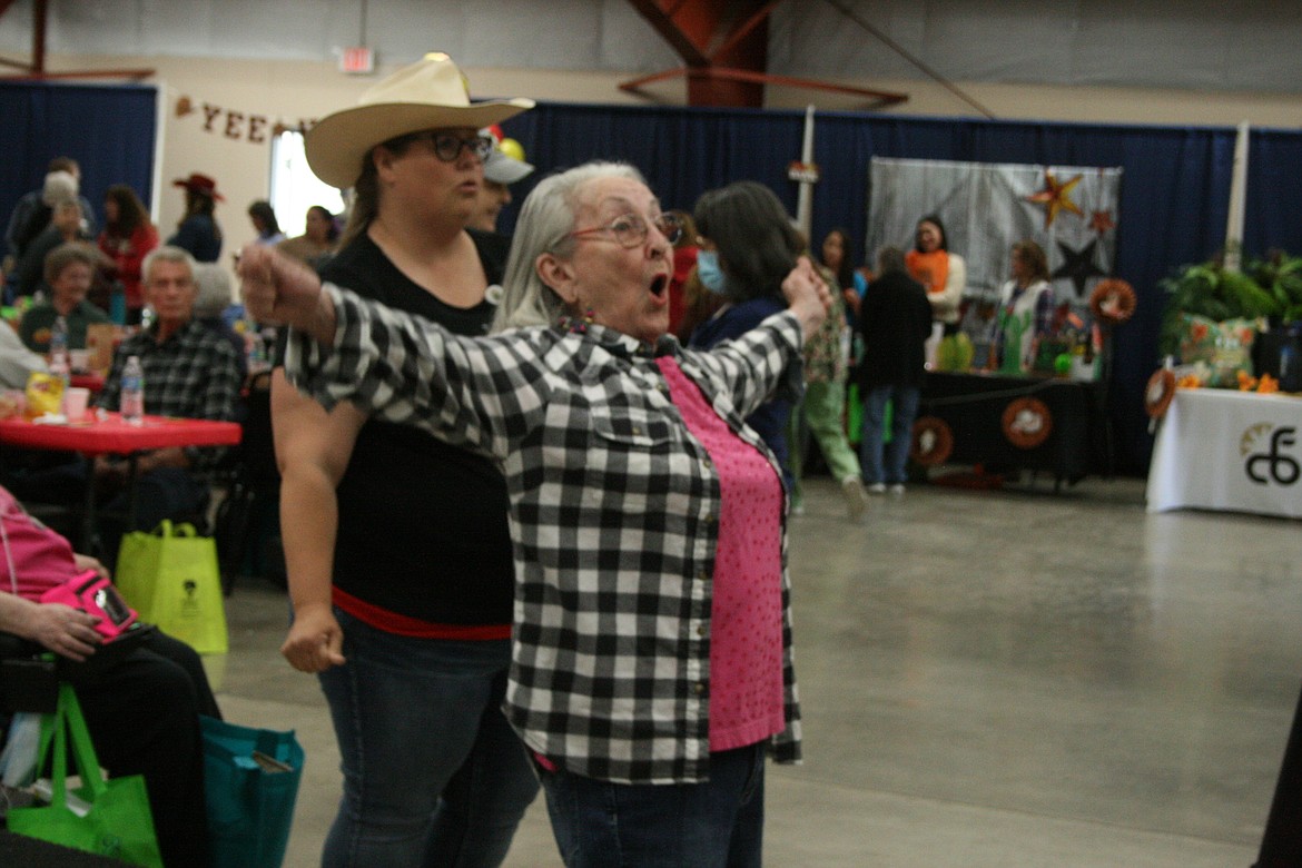 Betty Schafer sings along with the band during the Senior Picnic Wednesday at the Grant County Fairgrounds.