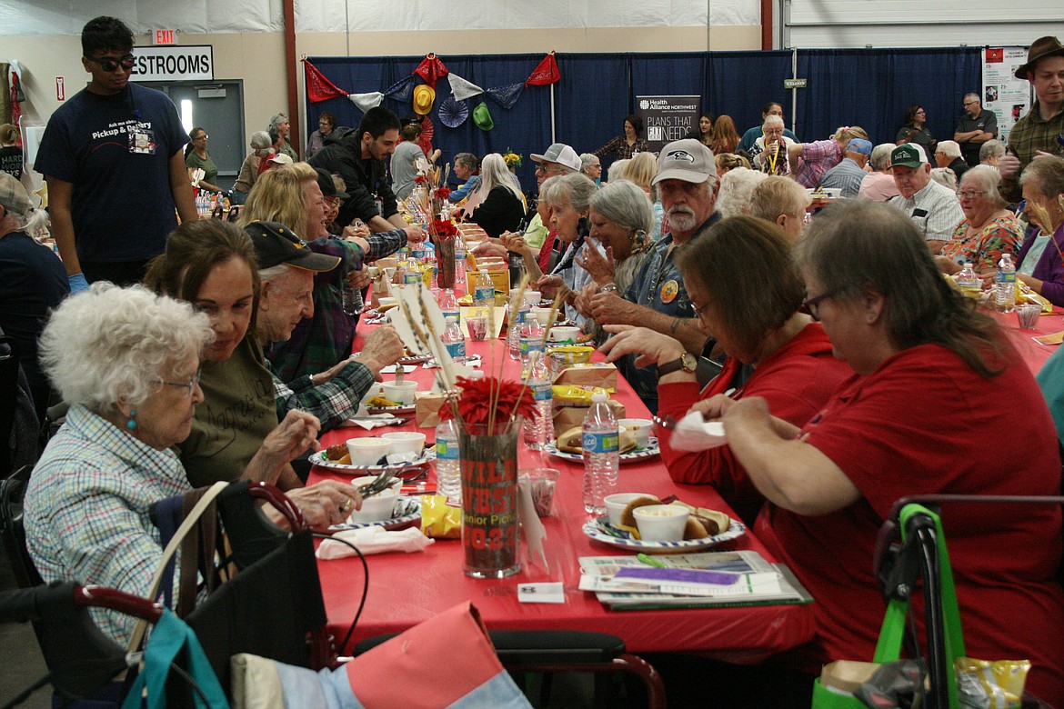 Attendees dig into their picnic lunch during the annual Senior Picnic. The picnic returned in person after two years of drive-thru events.