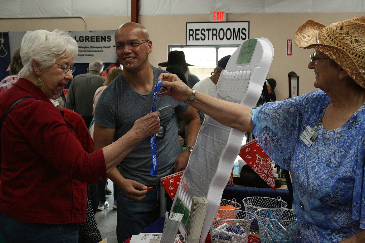 A Senior Picnic attendee gets a prize from one of the vendor booths.
