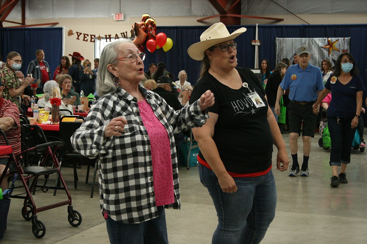 Betty Schafer (left) and Carrie Alexander (right) sing along with the band during the Senior Picnic.