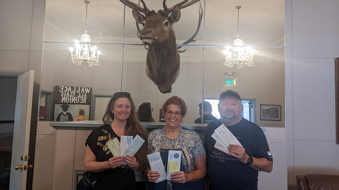 Sera White, Marcy Hayman and Mike Hayman posing at the Elks Lodge with grant funds received to update the building and continue providing meals to the community.