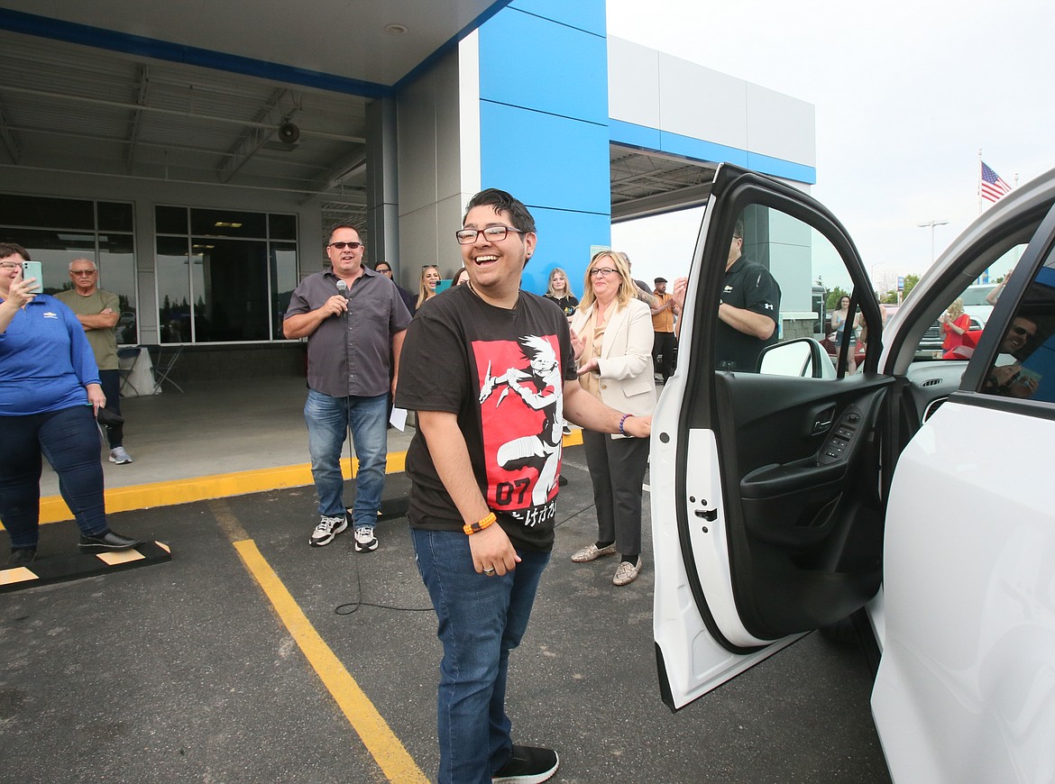 Post Falls High School graduate Malachi Silva reacts to winning a brand new 2022 Chevy Trax during Knudtsen Chevrolet's high school graduate car giveaway and community celebration Thursday.