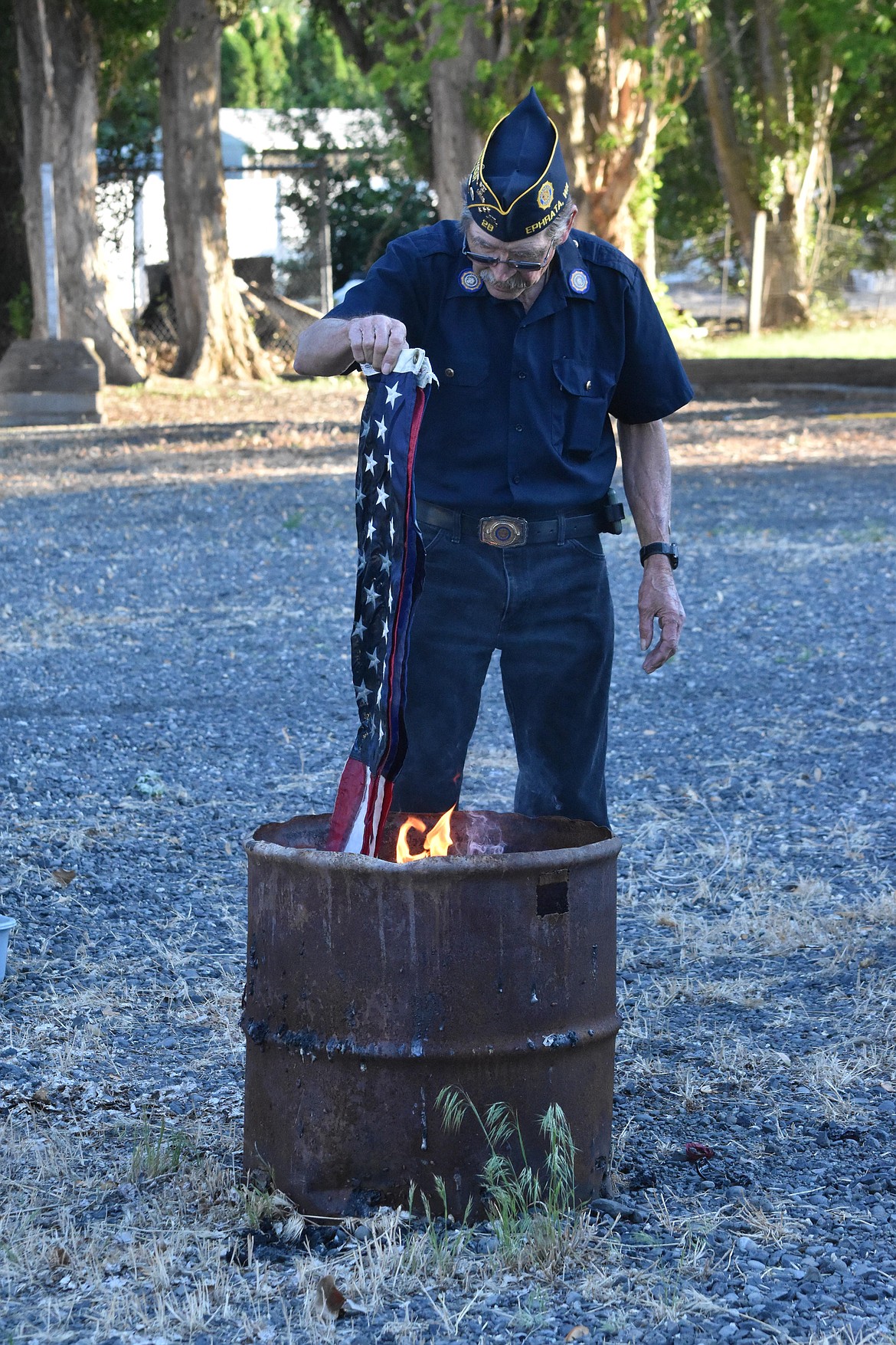 Ken Koplin put the first of dozens of flags into the fire on Wednesday just after the retirement ceremony concluded. Respectful cremation such as performed by the Legion is the appropriate way to dispose of worn-out U.S. flags.