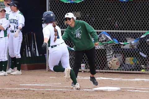 Big Bend softball head coach Kylee Brulotte, right, high-fives a player running the bases. Brulotte said recruiting isn't just about looking for the right skills, it's also about finding the right fit for the team.