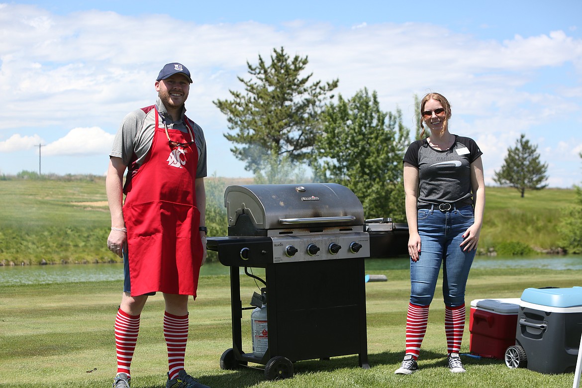 Donning the stylish socks of the Ronald McDonald House, some volunteers worked on the grill to feed the golfers throughout the day.