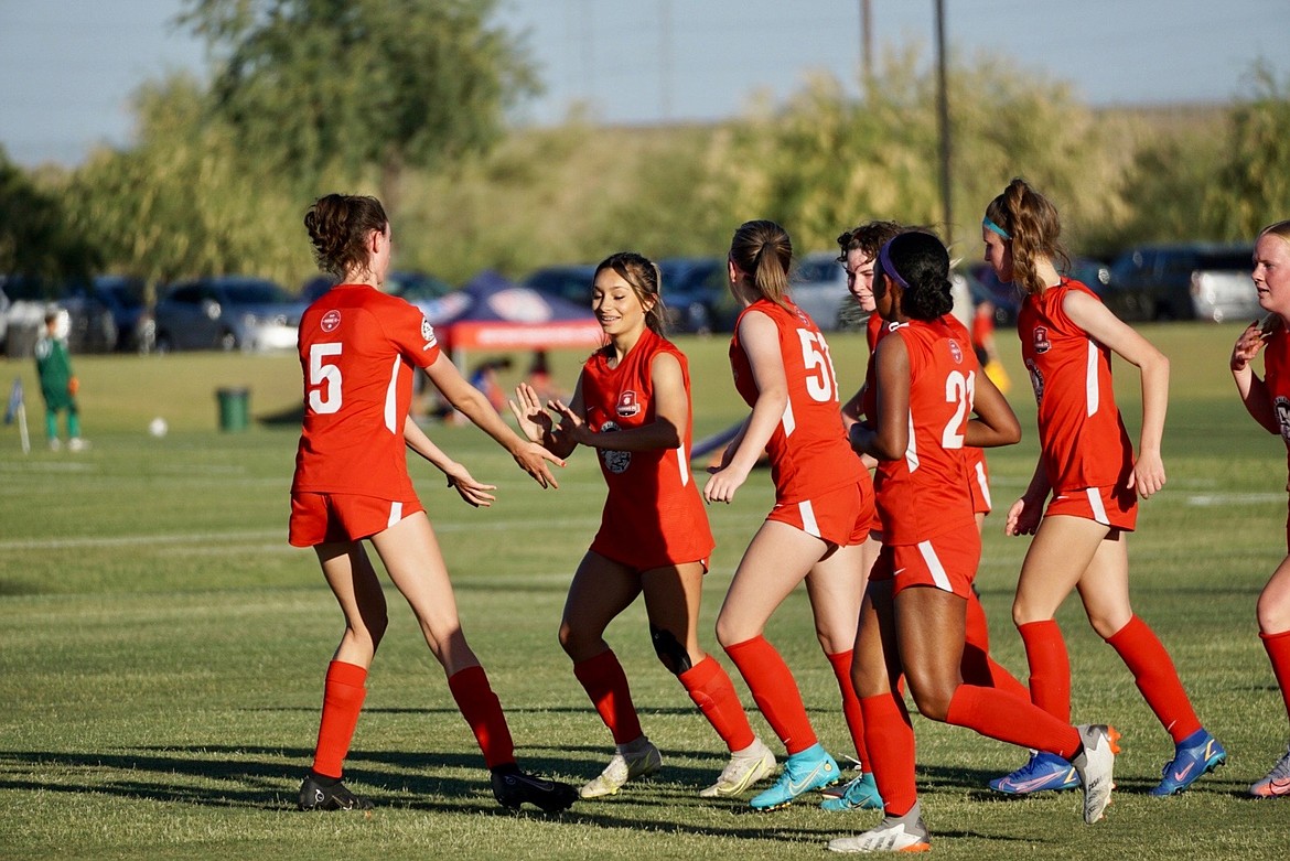 Photo by MARCEE HARTZELL 
Members of the Thorns North FC 2007 Girls Red soccer team celebrates a 5-0 win over Eugene FC on Wednesday at the USYS Far West President's Cup in Phoenix. From left are Izzy Olson, Marisol Stosich, Lily Bole (51) Grace Hatch (mostly obscured), Jamie Lawrence (21), Natalie Thompson and Kennedy Hartzell.