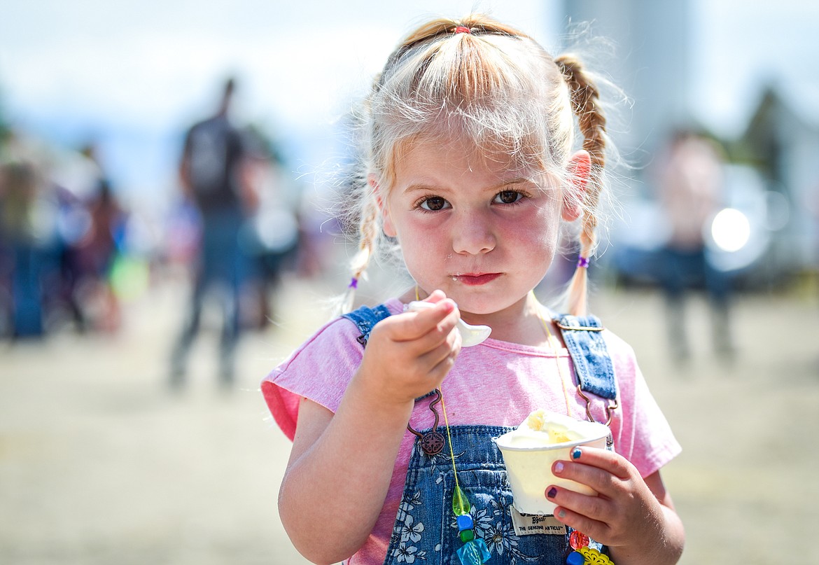 Emma Anvik, 3, enjoys a cup of vanilla ice cream at Kalispell Kreamery's Milk & Cookies event on Saturday, June 18. (Casey Kreider/Daily Inter Lake)