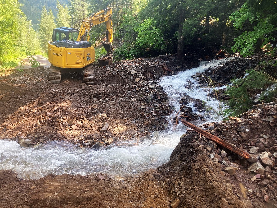 Crews work to repair Lightning Creek Road, which was damaged when debris washed into the creek plugged a culvert near Goat Mountain Trail.