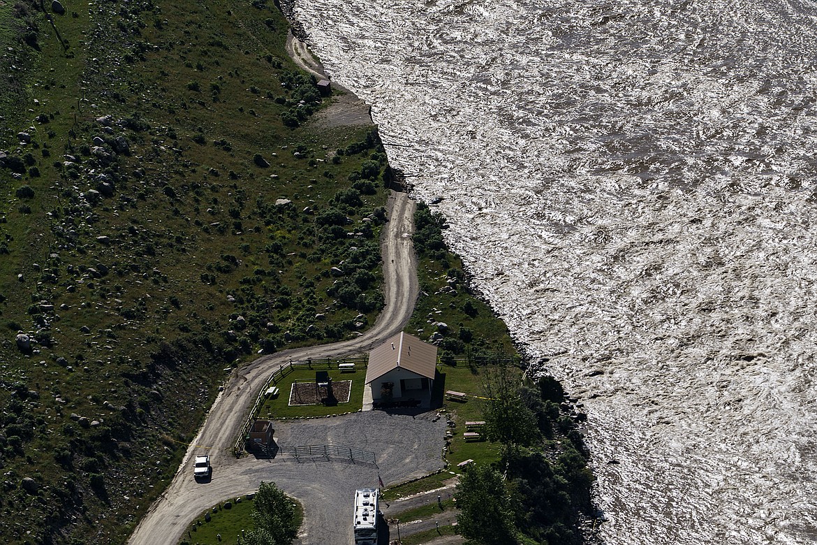 A road ends where floodwaters washed away a house in Gardiner, Mont., Thursday, June 16, 2022. (AP Photo/David Goldman)