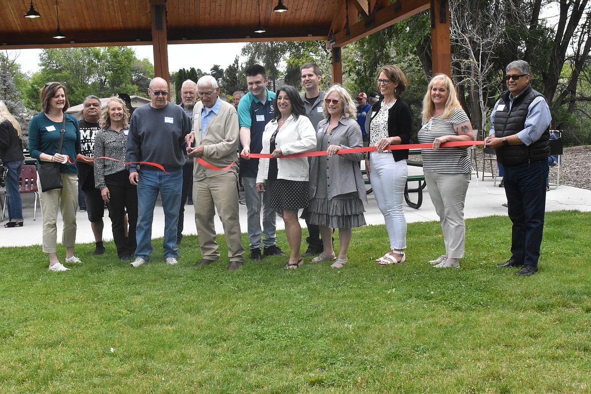 Dick Deane, surrounded by current city officials and his family, cut the ribbon for the dedication of Dick Deane Family Historical Park.