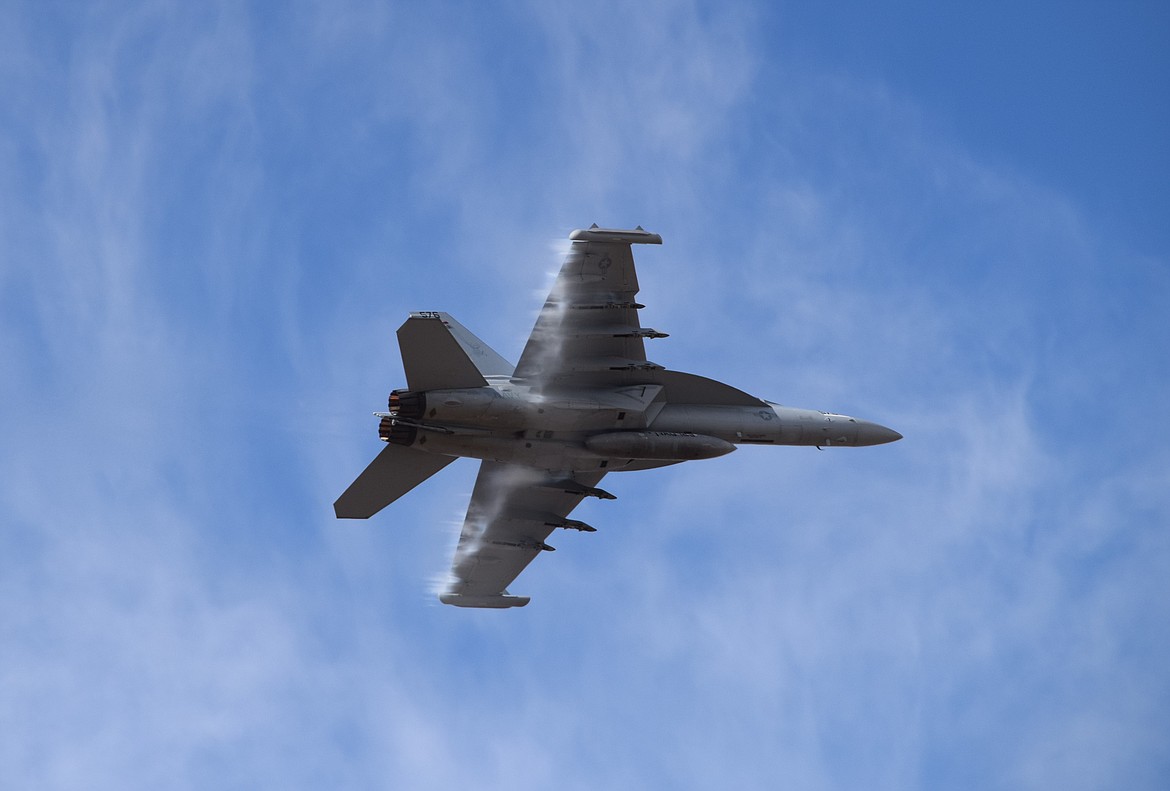 Vapor forms on the wings of a fast-moving U.S. Navy A/E-18G Growler during a demonstration flight at the 2022 Moses Lake Airshow on Saturday.