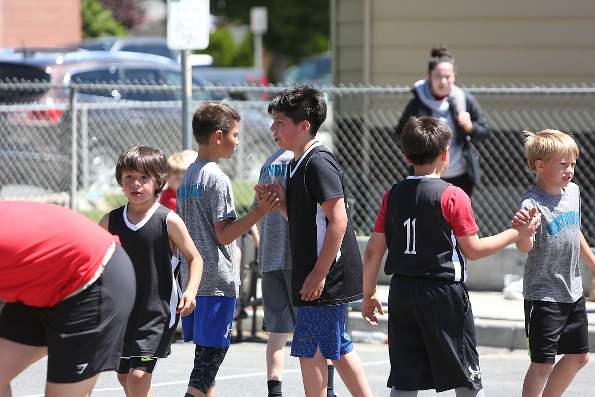 After a well-played game, opposing teams gathered for high fives in a demonstration of sportsmanship.